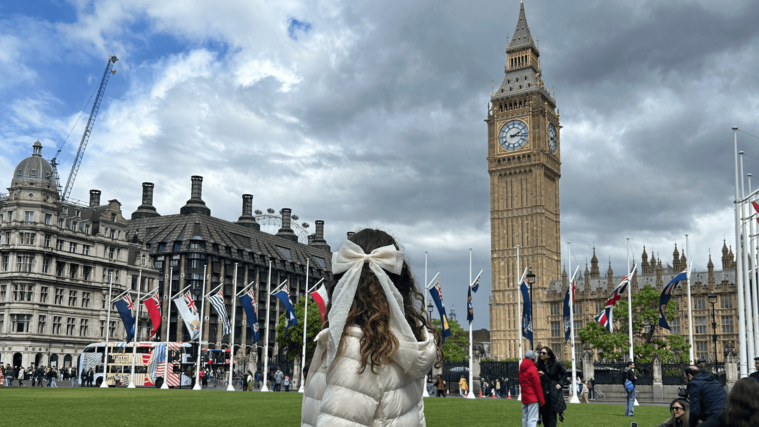 A girl facing Big Ben in London.