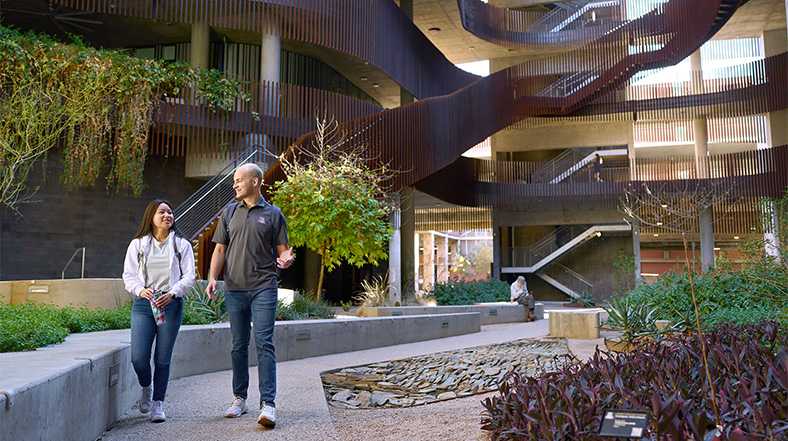Two students walking outside of ENR2