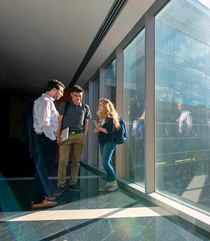 Business students talking in the building hallway