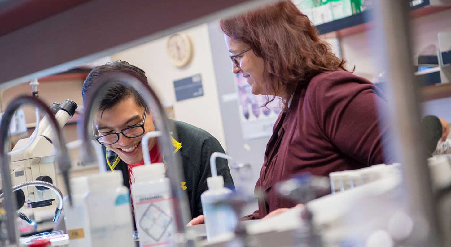 University of Arizona student and professor working in a lab