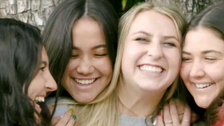 Four smiling students.