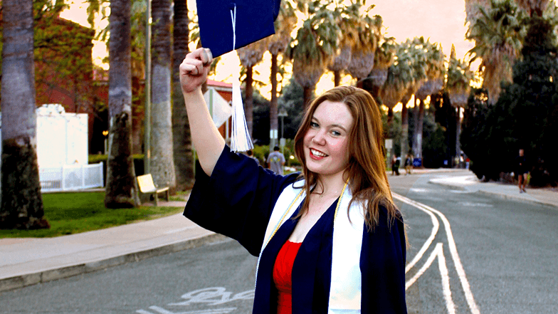 Graduating Wildcat Erika wears her cap and gown 